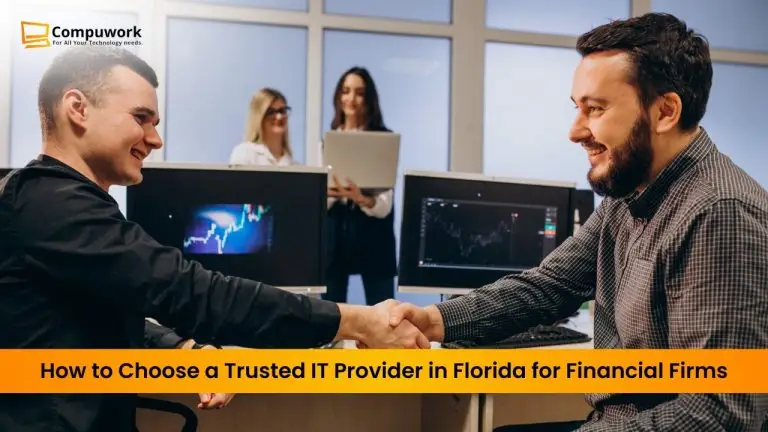 “Business professionals shaking hands in an office with computer monitors displaying financial data, representing choosing a trusted IT provider in Florida for financial firms.