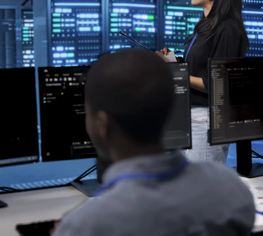 Manager in server hub using computer to find firewall misconfigurations affecting rackmounts performance. Supervisor checking systems bottlenecks leading to sluggish data transfer rates